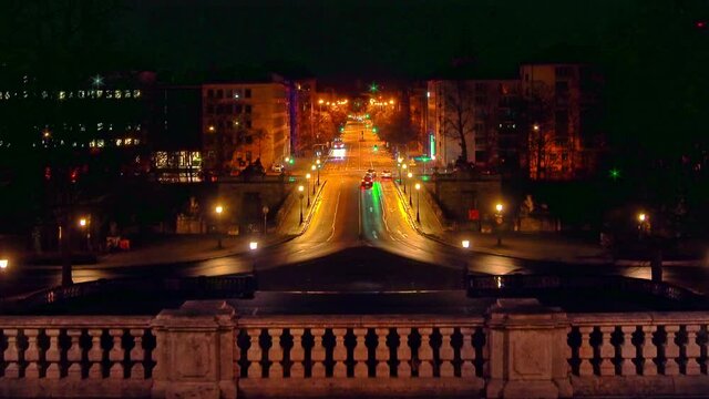 Traffic in Munich at night with the view over the popular Prinzregentenstra&szlig;e in the central of the baviarian capital - cars driving stop and go at traffic lightswith a smooth zoom out effect.