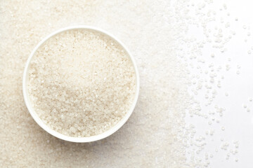 Close-up of organic white  sago or sabudana small size in white ceramic bowl with the gradient background of sago. Top view 