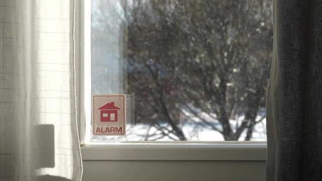 Home security Alarm sign on window of Domestic house, criminality on the rise