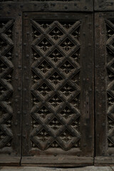 Seven-hundred-year-old entrance door to the basilica in Gdańsk. Carved door.