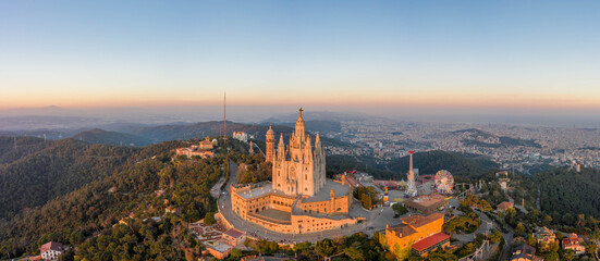 panoramic aerial drone view of Sacred Heart Basilica on top of Tibidabo near Barcelona during sunset