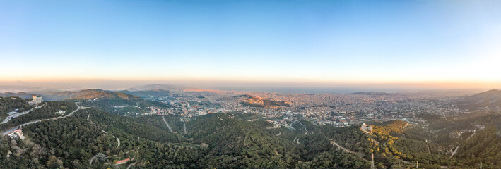 Panorama Aerial drone shot of Tibidabo Mountain with city view of Barcelona during sunset