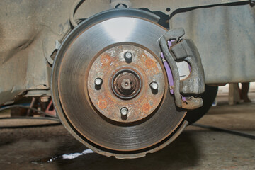 Front View of Car Wheel Hub and Brake Caliper System on Center Frame