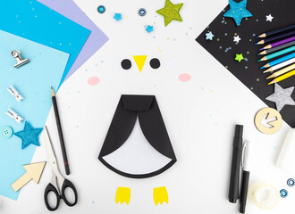 Step-by-step instruction of making a penguin out of paper with children. Step 4