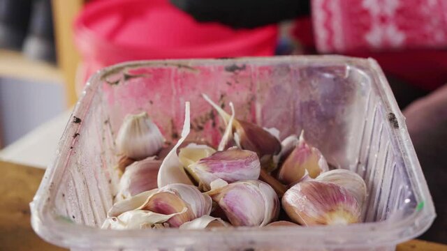 Peeling garlic cloves before winter storage