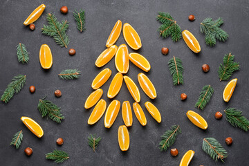 Christmas tree made of cut oranges on dark background