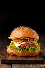 Close-up of home made tasty hamburger on wooden table.