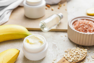 Composition with banana cosmetics on light background