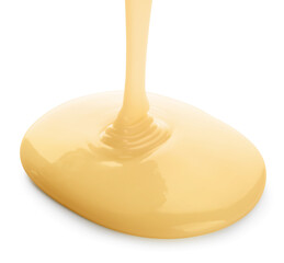 Pouring of condensed milk on white background