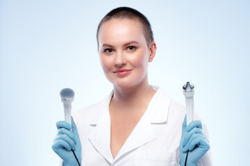 Fototapeta premium Portrait of a woman dermatologist holding cosmetic device attachment