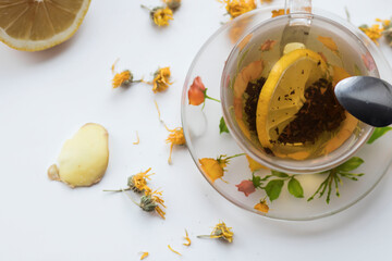 Green tea in a beautiful cup, with lemon and ginger