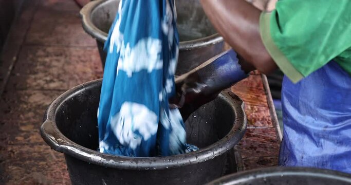 Blue dye batik fabric manufacture Accra Ghana. Local neighborhood fabric clothing manufacturing and craft center. Ghanaian family makes, teaches and instructs in the traditional.