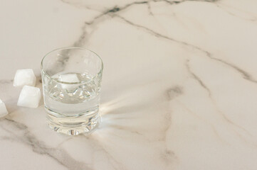 A glass of purified fresh drinking water on a marble table. copy space for text