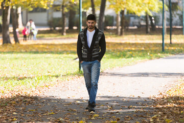 Attractive Man Walking In Autumn Forest