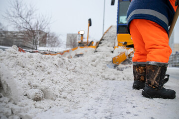 Snow plow and snow truck cleaning the streets during a snow storm in night maintenance action in Belgrade, Serbia