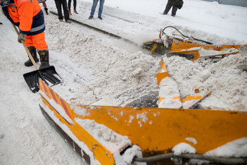 Tractor cleaning the road from the snow. Excavator cleans the streets of large amounts of snow in...