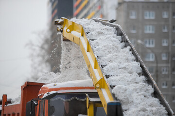 Snow plow and snow truck cleaning the streets during a snow storm in night maintenance action in...