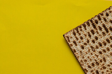 A close-up of a matzah- bread for the Jewish Passover, on a yellow background