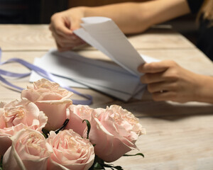 Young woman opening letters from her dearest relatives or friends. Get present for birthday....