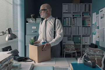 Businessman packing and leaving the office