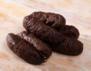 Blood sausage black pudding on wooden background