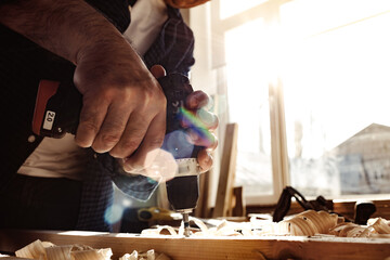 Close up of a carpenter drilling a hole in timber