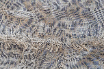 Rough hemp fabric on a wooden table.