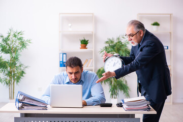 Old boss and his young assistant in the office