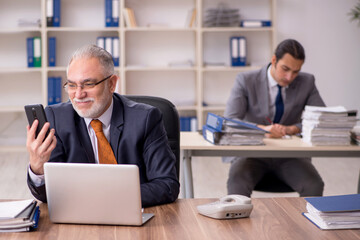 Obraz premium Two employees sitting at workplace