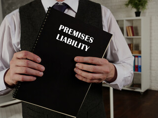 Lawyer holds PREMISES LIABILITY book. Premises liability is the liability that a landowner or...