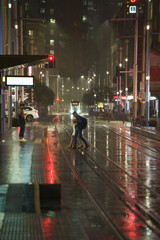 people walking in the rain in city