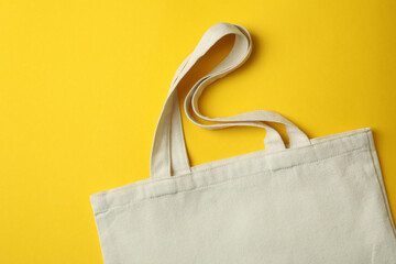 Blank eco bag on yellow background, space for text