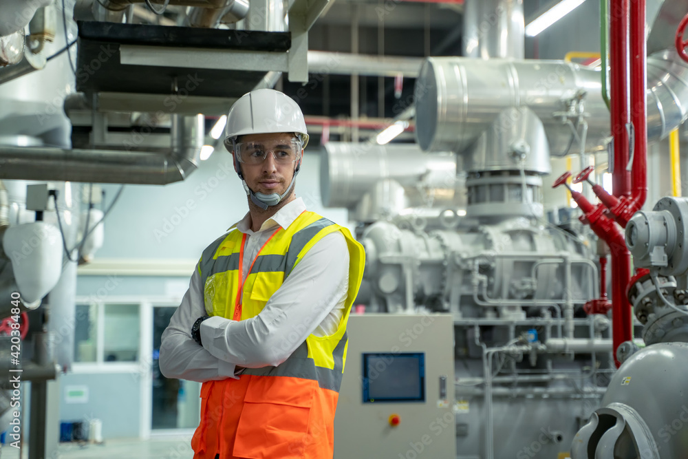 Poster Technician engineer checking controls system for security functions in service room at factory,Heating,Ventilation,Air Conditioning.