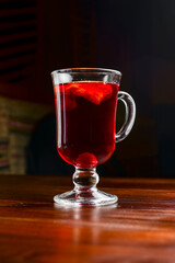 Closeup of mulled wine, in a glass over Traditional Ukrainian tablecloth. Christmas time, winter time.