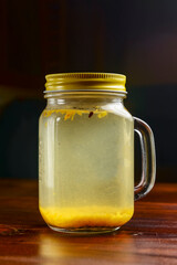 Ginger tea with lemon and mint over black background. Ukrainian cuisine concept, Christmas time.