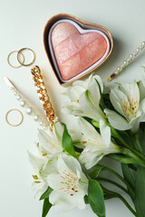 Female concept with jewelry and flowers on white background