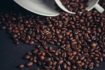 cup of coffee with brown beans on a gray background close-ups macro photography