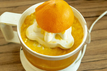 squeezing oranges fresh on the orange press with pulp