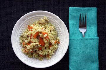 Flavorful pilaf of rice, carrots and chicken.