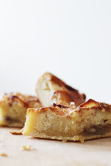 pieces of homemade apple pie with cinnamon on wooden board