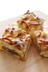 pieces of homemade apple pie with cinnamon on wooden board
