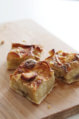 pieces of homemade apple pie with cinnamon on wooden board