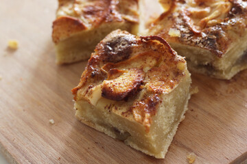 pieces of homemade apple pie with cinnamon on wooden board
