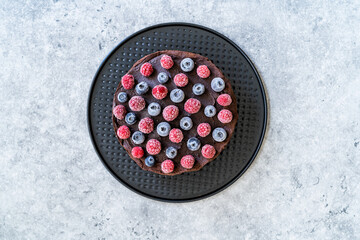 Gluten Free Vegan Chocolate Raw Cake with Raspberries and Blueberries.