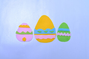 Colorful Easter eggs background cut out of fabric. Spring background