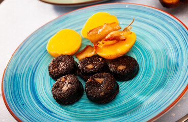 Fried blood sausage with potatoes served at plate, dish of Belarussian cuisine
