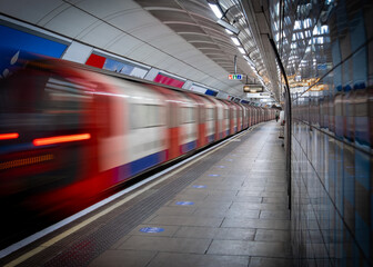 Motion blurred train on empty London Underground platform during the Covid 19 lockdown