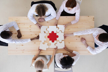 Business people assembling puzzle