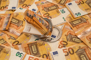 Handcuffs and euro banknotes