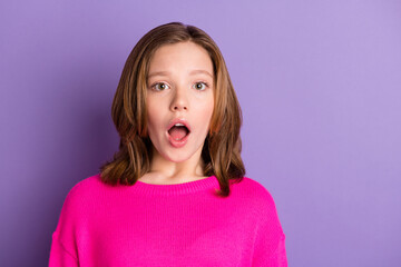 Photo of shocked scared little girl astonished fake news information isolated on purple color...